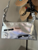 Step into the spotlight with this stunning metallic silver shoulder bag! 🌟 This